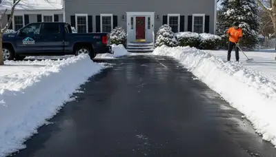 Cleared residential driveway after professional snow removal by Chop Chop Landscaping in Waltham, MA
