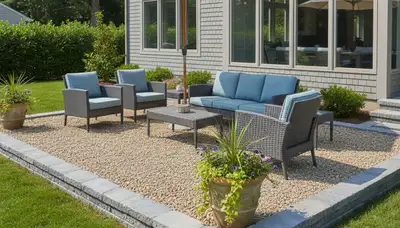 Pea gravel patio installation in Waltham MA with clean edging and outdoor seating by Chop Chop Landscaping